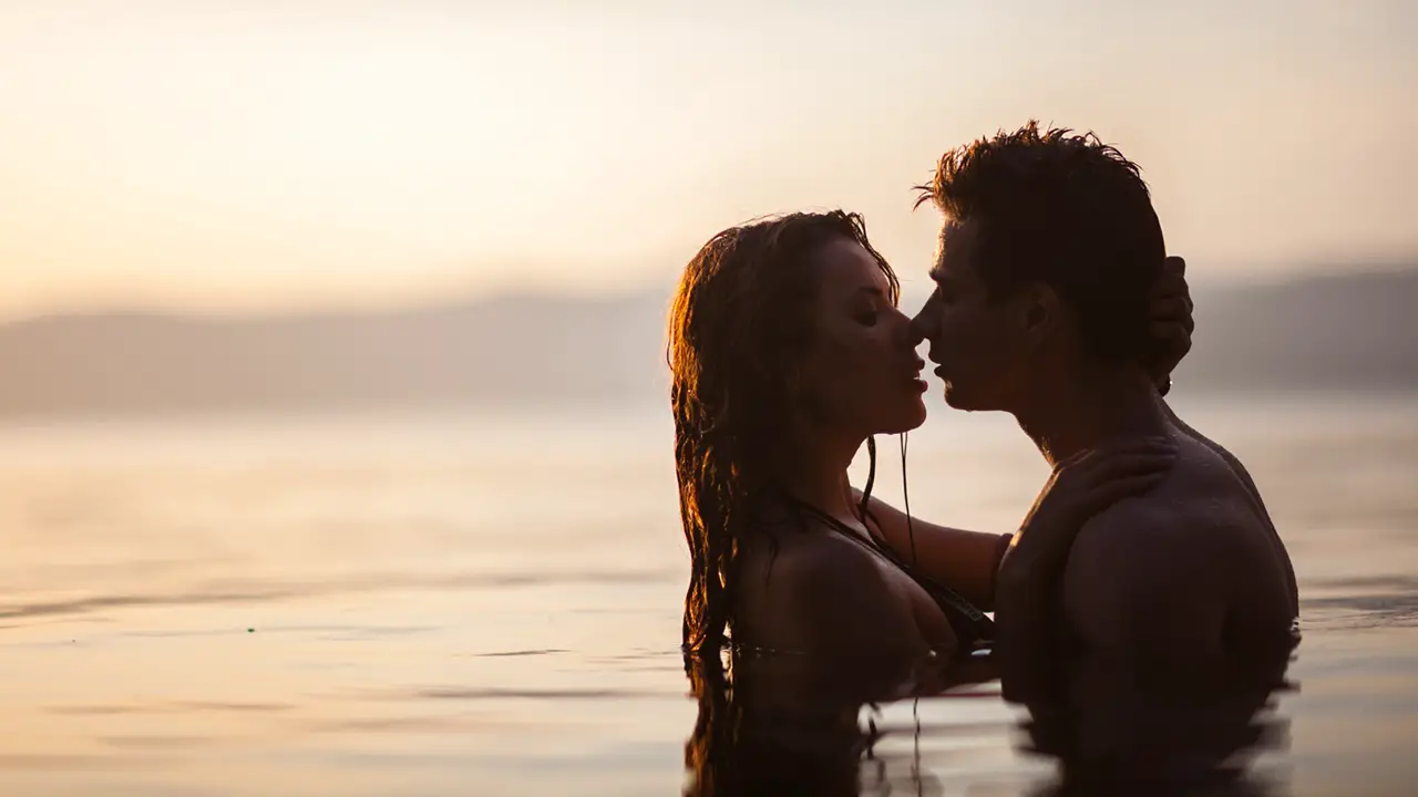 A couple kissing in a lake