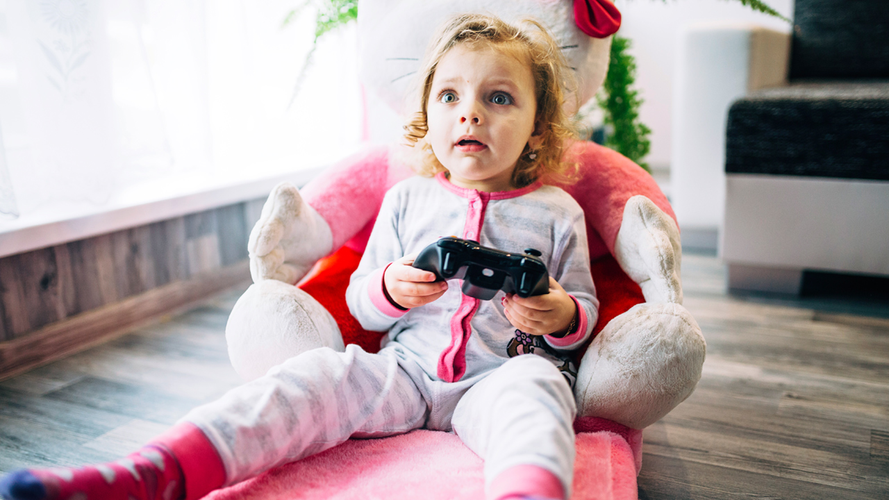 A shocked child probably playing a game she shouldn't be
