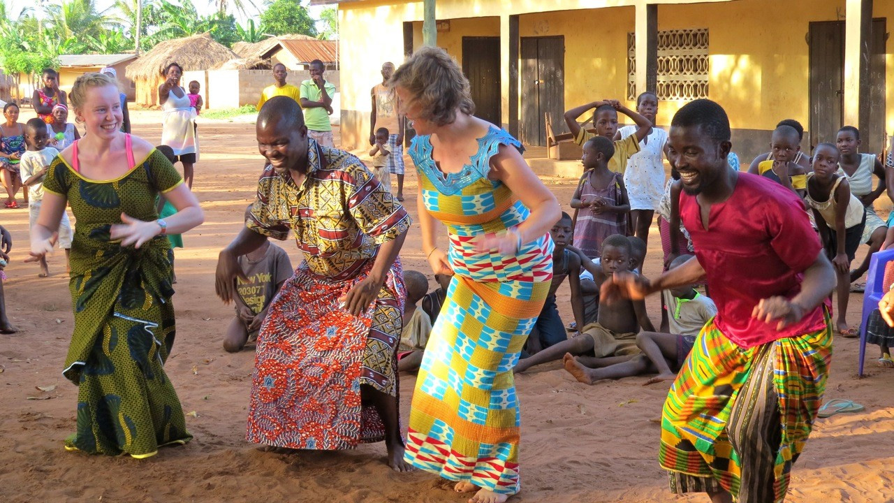 Ghanaians dancing happily with foreigners