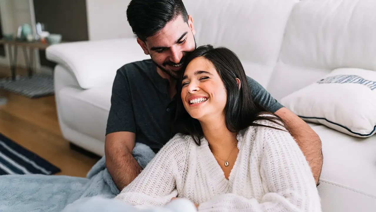 Couple on couch adoring each other