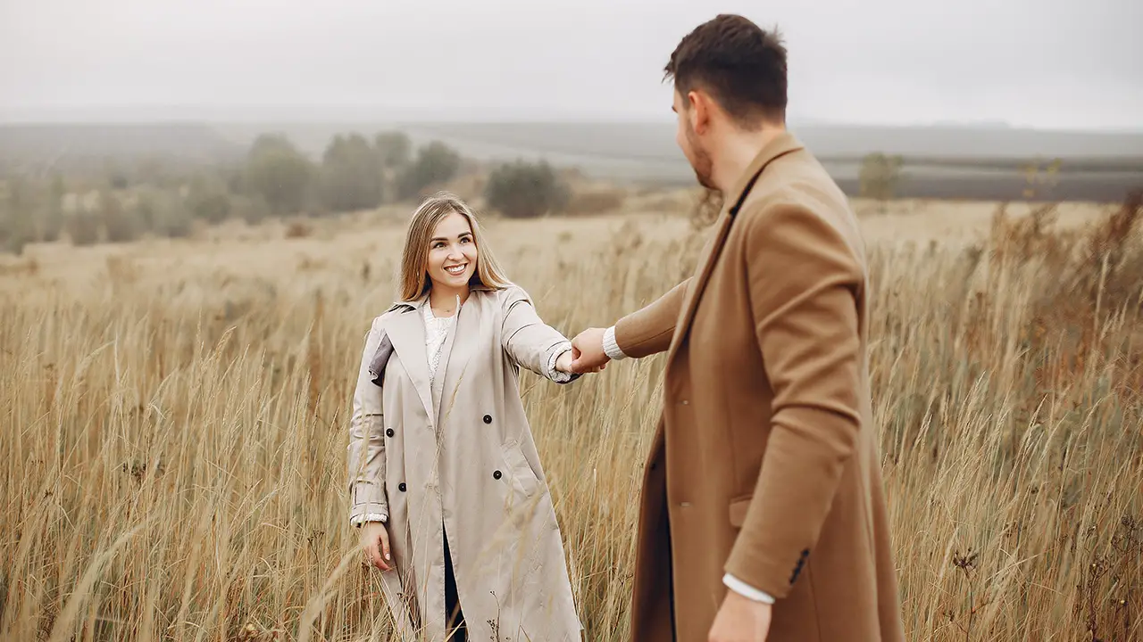 A beautiful couple spend time autumn field