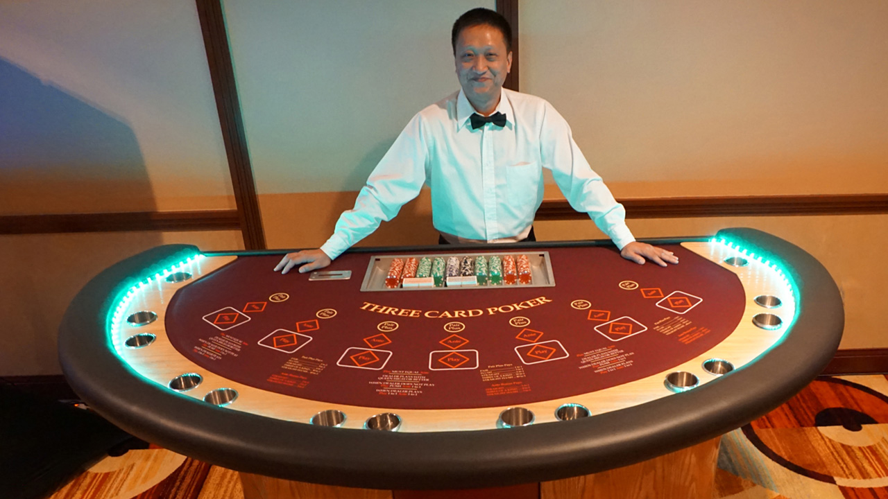 A happy dealer at the Let It Ride Poker table