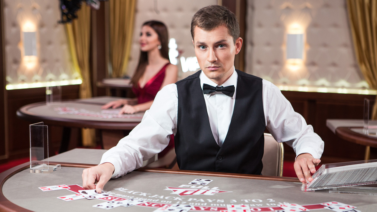 A handsome young Stud Poker dealer waiting for your next move