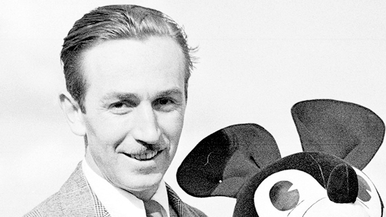 A black and white portrait of Walt Disney