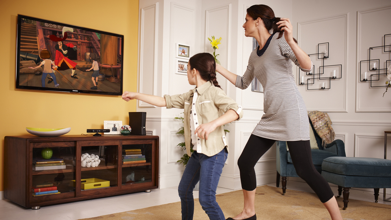 Daughter and mother playing Kinect video game