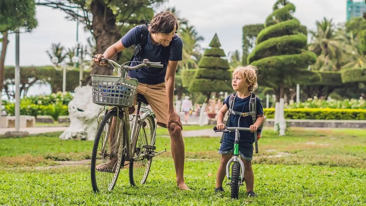 Father and son riding bike outside together