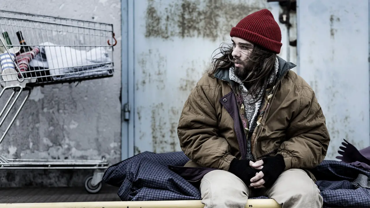 Homeless man sits at the street