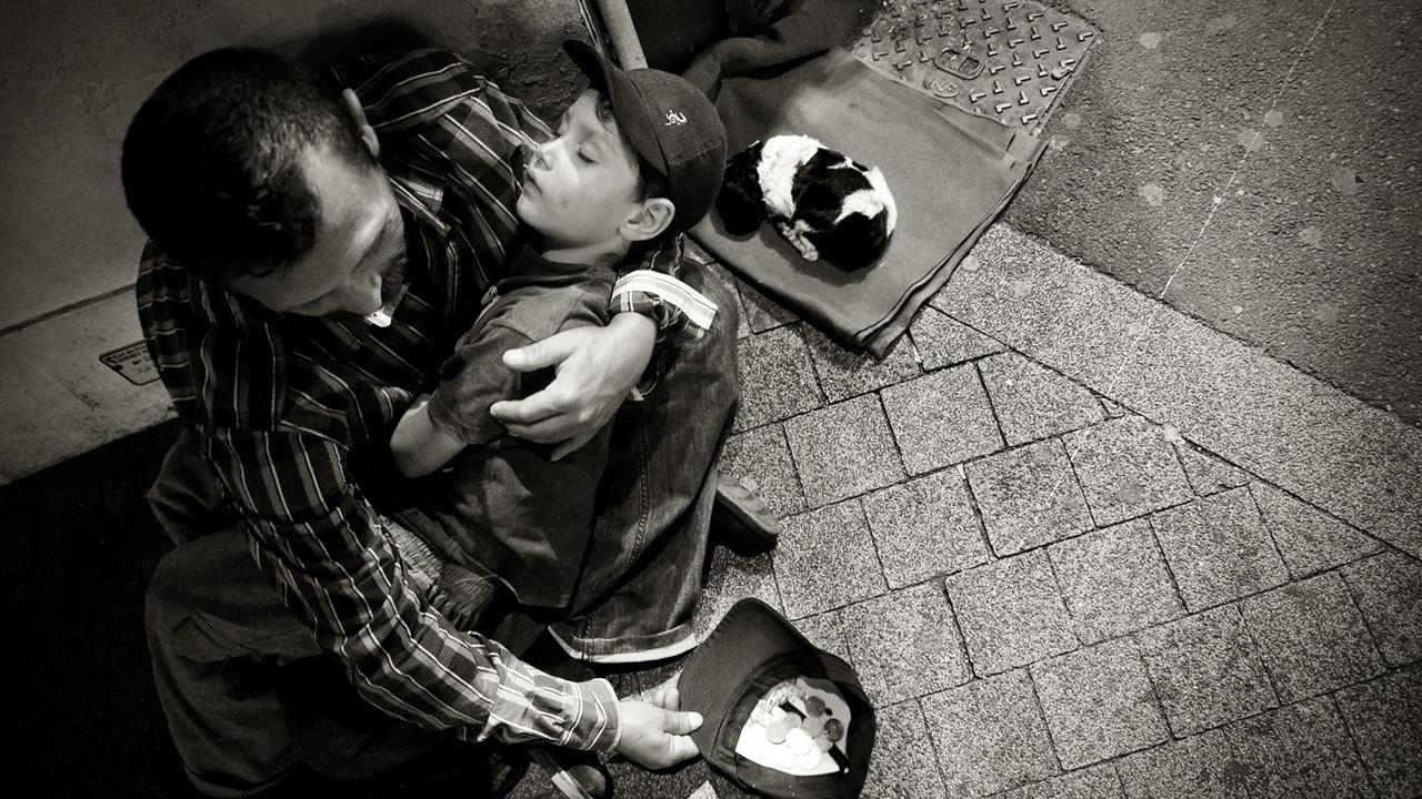A homeless man with child and puppy