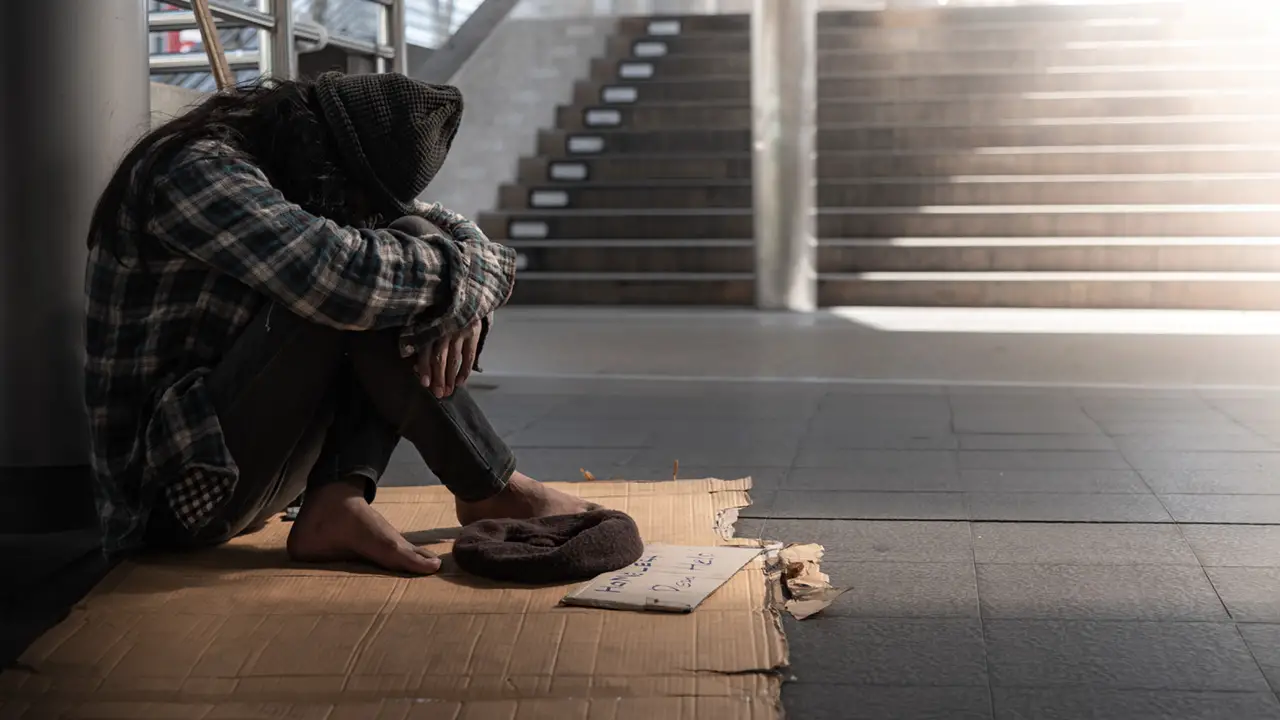 Homeless person sitting on the floor