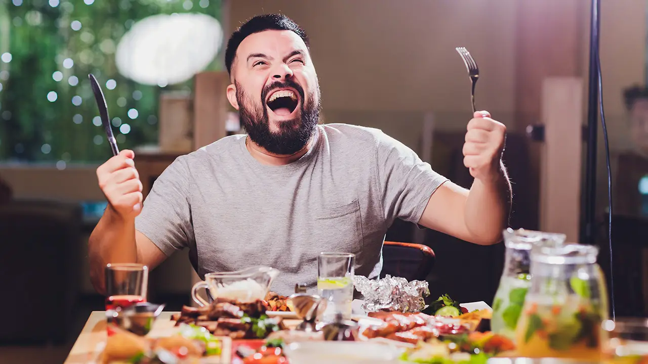 A happy man eating GMO foods